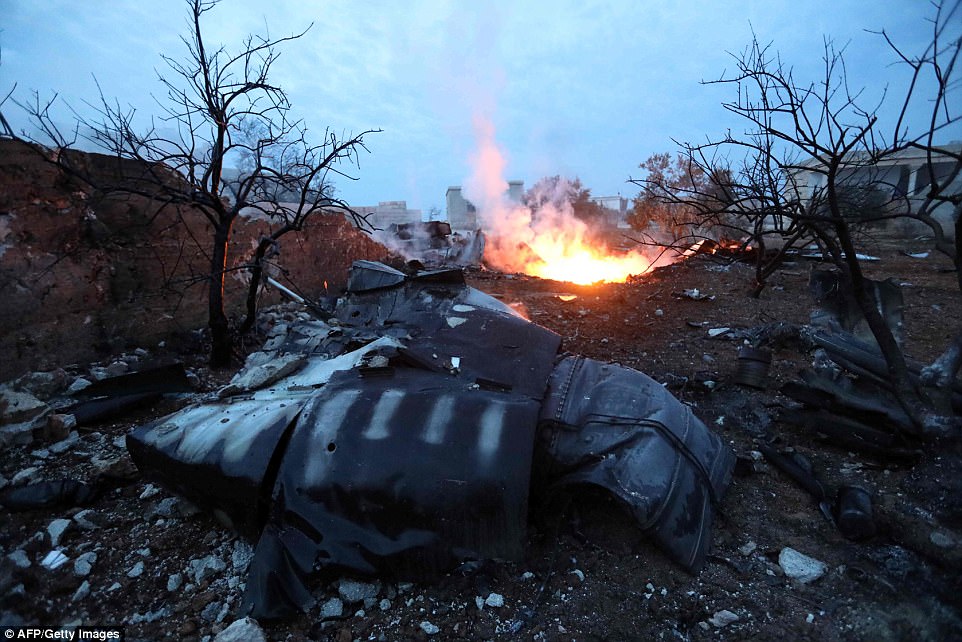 http://i.dailymail.co.uk/i/pix/2018/02/03/16/48D8D89700000578-5348005-Smoke_billowing_from_the_site_of_a_downed_Sukhoi_25_fighter_jet_-a-48_1517676634512.jpg